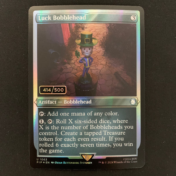 [FOIL] Luck Bobblehead (Serialized) - Universes Beyond: Fallout: Extras - NM