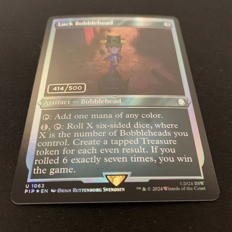 [FOIL] Luck Bobblehead (Serialized) - Universes Beyond: Fallout: Extras - NM