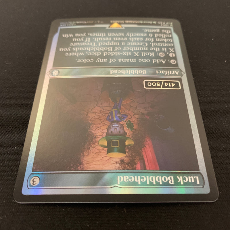 [FOIL] Luck Bobblehead (Serialized) - Universes Beyond: Fallout: Extras - NM