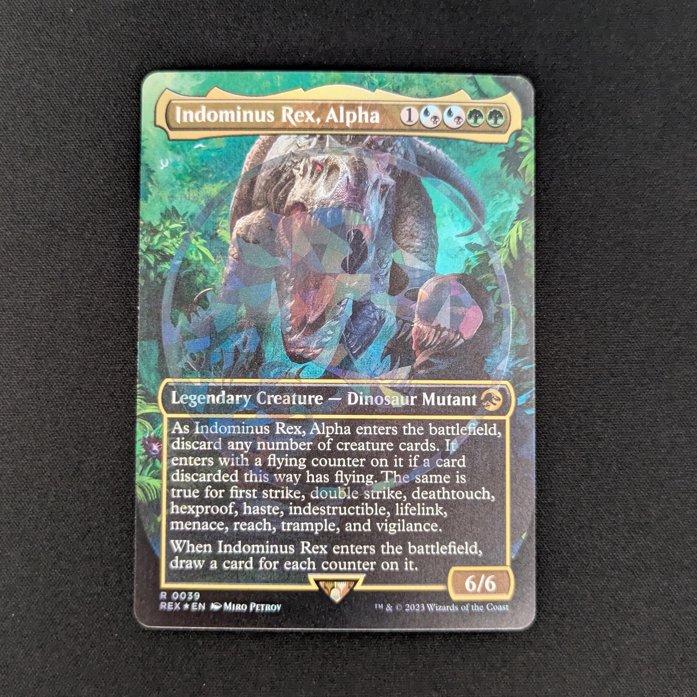 [FOIL] Indominus Rex, Alpha (Emblem Foil) - Universes Beyond: Jurassic World Collection - NM